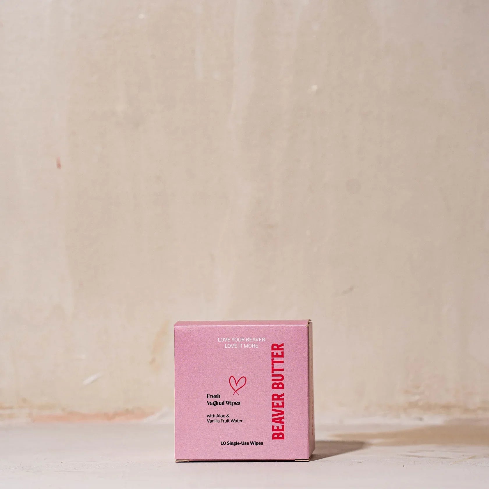 A pink box of Beaver Butter Fresh Vaginal Wipes by ECN against a white wall.